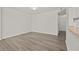 Bright living room featuring wood-look laminate flooring, a white wall, and minimalist style at 242 Coco Plum Dr, Davenport, FL 33897