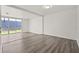 Bright living room with laminate flooring, sliding glass door, and neutral wall color at 242 Coco Plum Dr, Davenport, FL 33897