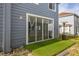 A small back patio featuring artifical turf at 242 Coco Plum Dr, Davenport, FL 33897