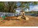 Fun playground with slides and climbing structures, surrounded by mulch and shaded by a large tree at 242 Coco Plum Dr, Davenport, FL 33897