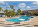 A clear blue community pool surrounded by palm trees and lounge chairs at 242 Coco Plum Dr, Davenport, FL 33897