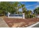 Entrance to Island Club West community, showcasing landscaping and signage at 242 Coco Plum Dr, Davenport, FL 33897