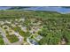 An aerial view showcasing the neighborhood near the lake surrounded by mature trees at 2420 Heron Ct, St Cloud, FL 34769