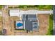Overhead view featuring pool, home, detached garage, driveway and manicured landscaping at 2420 Heron Ct, St Cloud, FL 34769
