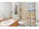 Bathroom featuring a vanity, toilet, tub, and shower, with beach-themed shower curtain at 2420 Heron Ct, St Cloud, FL 34769