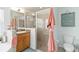 Bright bathroom featuring wood cabinets, and a clear glass enclosed shower at 2420 Heron Ct, St Cloud, FL 34769