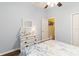 This stylish bedroom features nautical accents, wood floors, and a door to the bathroom at 2420 Heron Ct, St Cloud, FL 34769