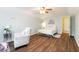 Airy bedroom boasts a ceiling fan, plush chair, and calming decor for a tranquil retreat at 2420 Heron Ct, St Cloud, FL 34769
