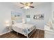 This stylish bedroom features nautical accents, wood floors, and a modern ceiling fan at 2420 Heron Ct, St Cloud, FL 34769