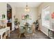 Cozy dining room featuring a glass-top table, unique chandelier, and ample natural light at 2420 Heron Ct, St Cloud, FL 34769
