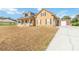 Inviting two-story home with a long driveway leading to a detached garage at 2420 Heron Ct, St Cloud, FL 34769