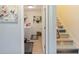 Hallway view of the laundry room and stairs with decorative coastal-themed stair risers at 2420 Heron Ct, St Cloud, FL 34769