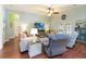 Comfortable living room with ample seating, a ceiling fan, and stylish furnishings at 2420 Heron Ct, St Cloud, FL 34769