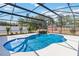 Stunning screened pool with a rock waterfall feature in the backyard at 2420 Heron Ct, St Cloud, FL 34769