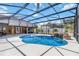 Beautiful screened pool with waterfall feature and covered patio area at 2420 Heron Ct, St Cloud, FL 34769