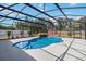Screened pool with waterfall feature and view of the backyard shed at 2420 Heron Ct, St Cloud, FL 34769