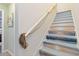 Unique staircase featuring coastal-themed art on the risers and rope handrail for a nautical feel at 2420 Heron Ct, St Cloud, FL 34769