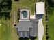 An aerial view of a home highlighting the screened pool, spacious backyard, and detached garage at 2420 Heron Ct, St Cloud, FL 34771