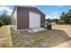 Exterior view of a metal garage with a roll-up door at 2420 Heron Ct, St Cloud, FL 34771