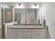 Elegant bathroom featuring granite countertops, double sinks, and a large mirror for a luxurious feel at 2423 Datura Loop, St Cloud, FL 34772
