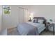 Cozy bedroom features soft lighting, neutral bedding, and closet with sliding doors for added convenience at 2423 Datura Loop, St Cloud, FL 34772