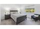 Comfortable bedroom featuring neutral decor, natural light, and an accent chair for a relaxing retreat at 2423 Datura Loop, St Cloud, FL 34772