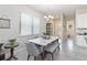 Bright dining area with a marble table, stylish chairs, and a modern chandelier at 2423 Datura Loop, St Cloud, FL 34772