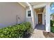 Inviting home entrance with a covered porch, tiled walkway and lush green landscaping at 2423 Datura Loop, St Cloud, FL 34772