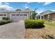 Well-maintained home featuring a two-car garage and a beautifully paved driveway, surrounded by a green lawn at 2423 Datura Loop, St Cloud, FL 34772
