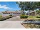 Charming tan home featuring a two-car garage and a beautifully paved driveway and walkway at 2423 Datura Loop, St Cloud, FL 34772