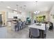 Well-equipped kitchen with stainless steel appliances, an island, and seating, open to the living space at 2423 Datura Loop, St Cloud, FL 34772