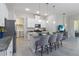 Bright kitchen features granite countertops, stainless appliances, an island with seating, and convenient laundry access at 2423 Datura Loop, St Cloud, FL 34772