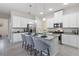 Bright open kitchen with a granite island, stainless steel appliances, and white cabinetry at 2423 Datura Loop, St Cloud, FL 34772