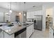 Modern kitchen boasts granite countertops, stainless steel appliances, a spacious island, and ample storage space at 2423 Datura Loop, St Cloud, FL 34772