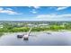 Picturesque lake view featuring a dock, boathouse, and the community's array of resort-style amenities at 2423 Datura Loop, St Cloud, FL 34772