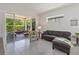 Bright living room with tile floors, comfortable seating, and sliding glass doors to the screened patio at 2423 Datura Loop, St Cloud, FL 34772