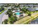 Aerial view of a community pool surrounded by palm trees, lounge chairs, and well-maintained landscaping at 2423 Datura Loop, St Cloud, FL 34772