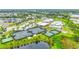 Aerial view features tennis courts and resort style amenities including a clubhouse, and pools at 2423 Datura Loop, St Cloud, FL 34772