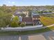 Aerial view of the home's backyard with a privacy fence, trees, and green space at 2504 London Bridge Ct, Orlando, FL 32837