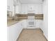 Bright kitchen featuring white cabinetry, complementing backsplash, and modern appliances at 2504 London Bridge Ct, Orlando, FL 32837