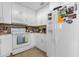 Bright kitchen featuring white appliances, cabinets, and a functional layout at 2504 London Bridge Ct, Orlando, FL 32837