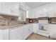 Modern kitchen with white cabinets, granite countertops, stainless steel appliances, and tiled backsplash at 2504 London Bridge Ct, Orlando, FL 32837