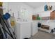 Functional laundry room with washer, dryer, and shelving for storage at 2504 London Bridge Ct, Orlando, FL 32837