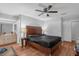 Bedroom with a ceiling fan, wood floor and view to the on-suite bathroom at 2504 London Bridge Ct, Orlando, FL 32837
