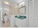Cozy bathroom with a glass block accent and framed mirror at 2610 Cloudcroft Dr, Apopka, FL 32703