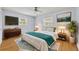 This primary bedroom features a ceiling fan, television, and a modern dresser at 2610 Cloudcroft Dr, Apopka, FL 32703