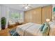 Bright bedroom with sitting area, built-in storage, and large windows offering a serene view at 2610 Cloudcroft Dr, Apopka, FL 32703
