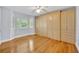 Bedroom featuring wood floors, large built-in wardrobe and natural light at 2610 Cloudcroft Dr, Apopka, FL 32703