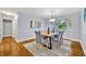 Elegant dining room with a modern table, stylish chairs, and a decorative light fixture at 2610 Cloudcroft Dr, Apopka, FL 32703