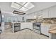Bright kitchen featuring white cabinets, stainless steel appliances, and a stylish backsplash at 2610 Cloudcroft Dr, Apopka, FL 32703